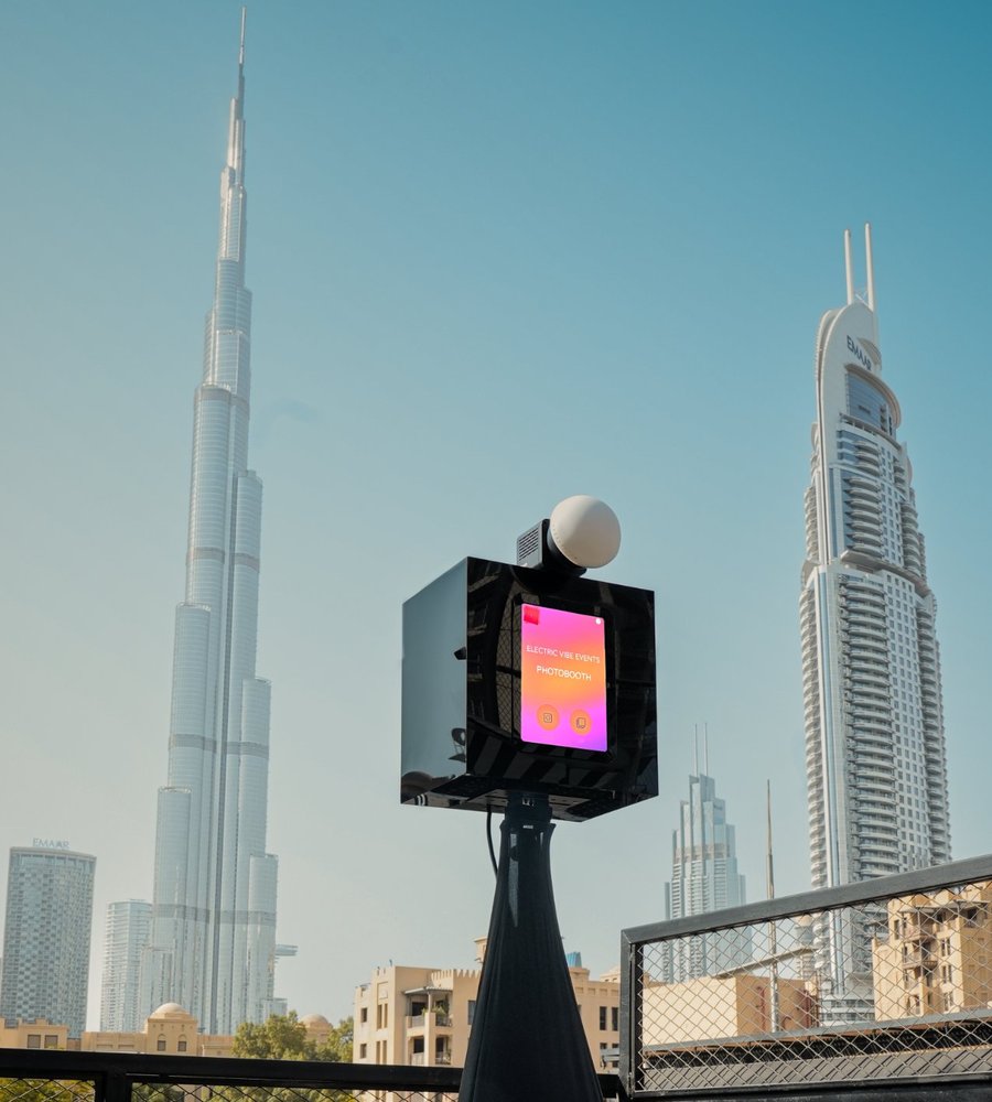 Black Electric Vibe photo booth on a rooftop with the Burj Khalifa behind it