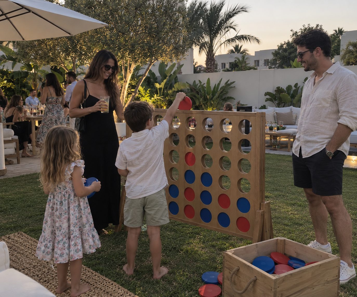 Family playing giant Connect Four at a garden party