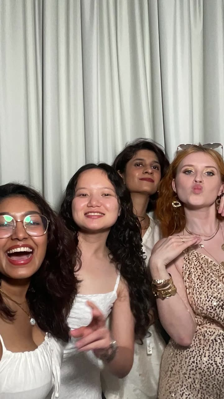 Friends laughing in the photo booth